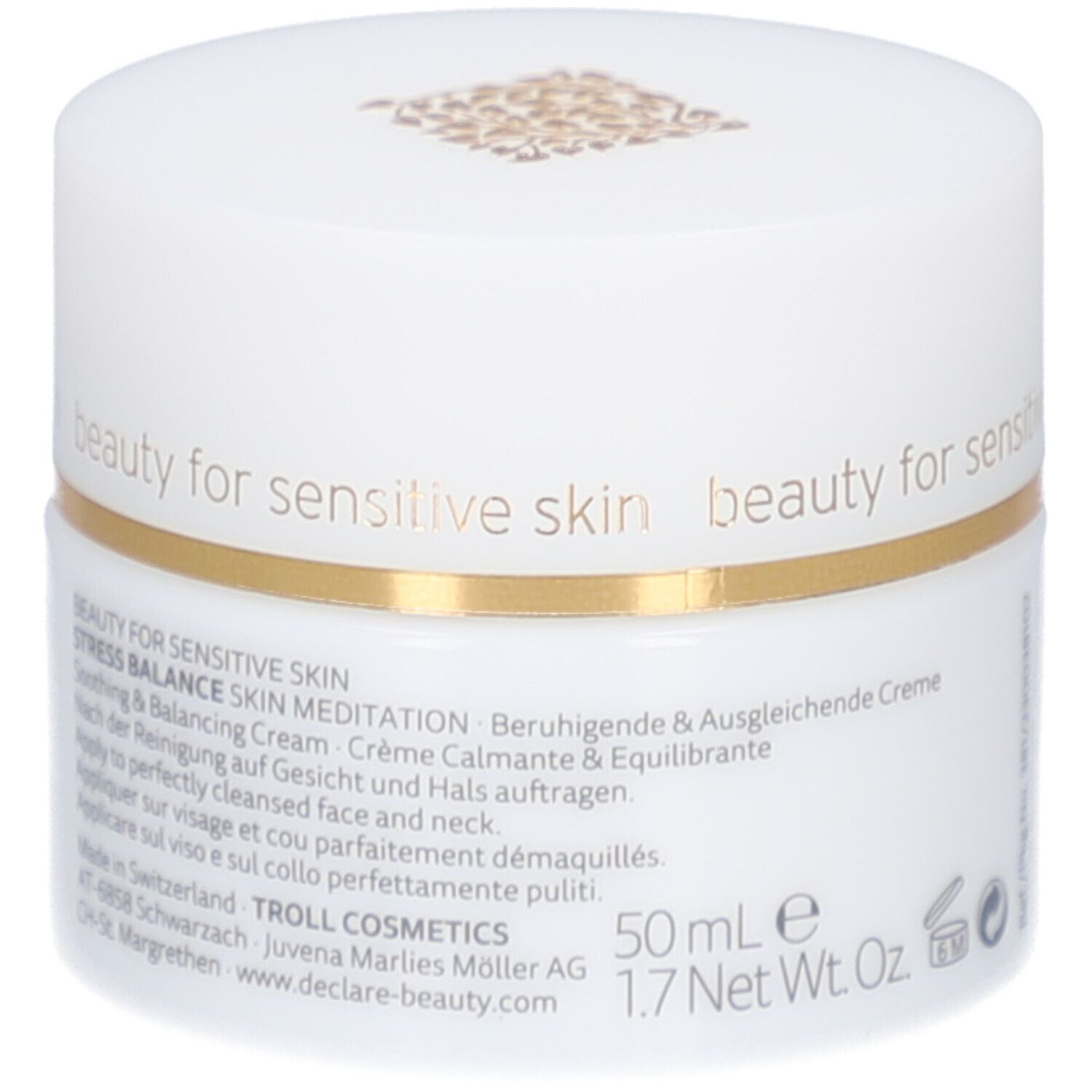 Vasetto di crema bianco con bordo dorato. Scritta: DECLARÉ SWITZERLAND, Skin Meditation Cream. Testo sul lato.