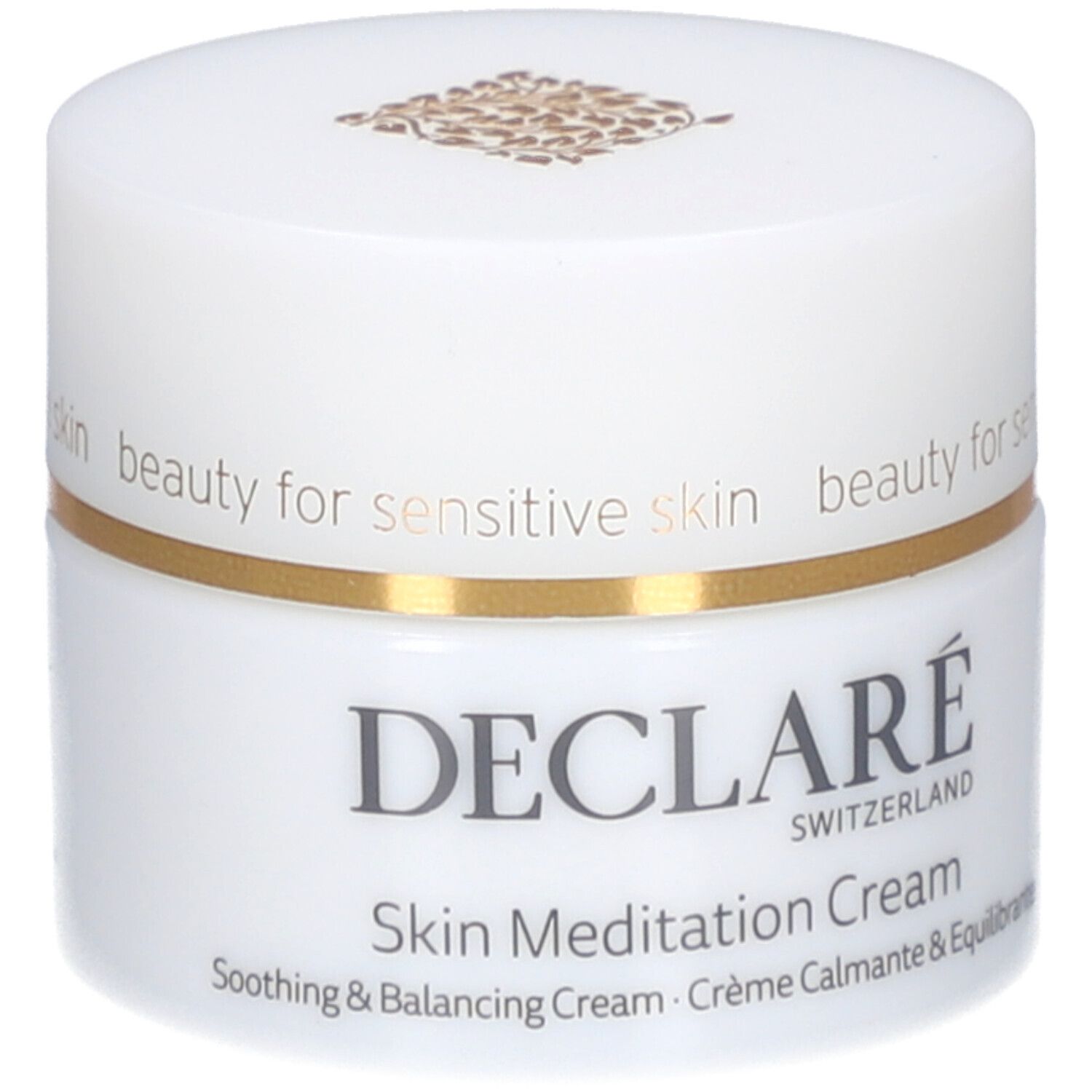 Vasetto di crema bianco con bordo dorato. Scritta: DECLARÉ SWITZERLAND, Skin Meditation Cream. Crema lenitiva e riequilibrante.