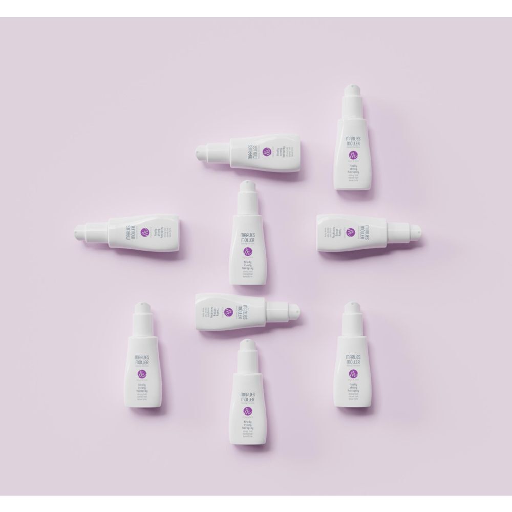 Diversi flaconi di lacca su sfondo viola. Logo Marlies Möller e nome del prodotto.