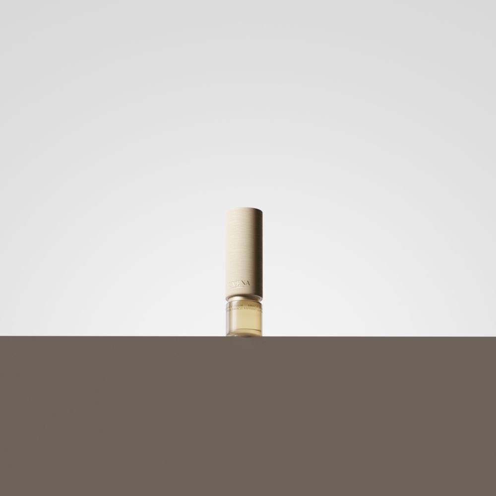 Flacone di siero con tappo dorato. Su sfondo marrone.