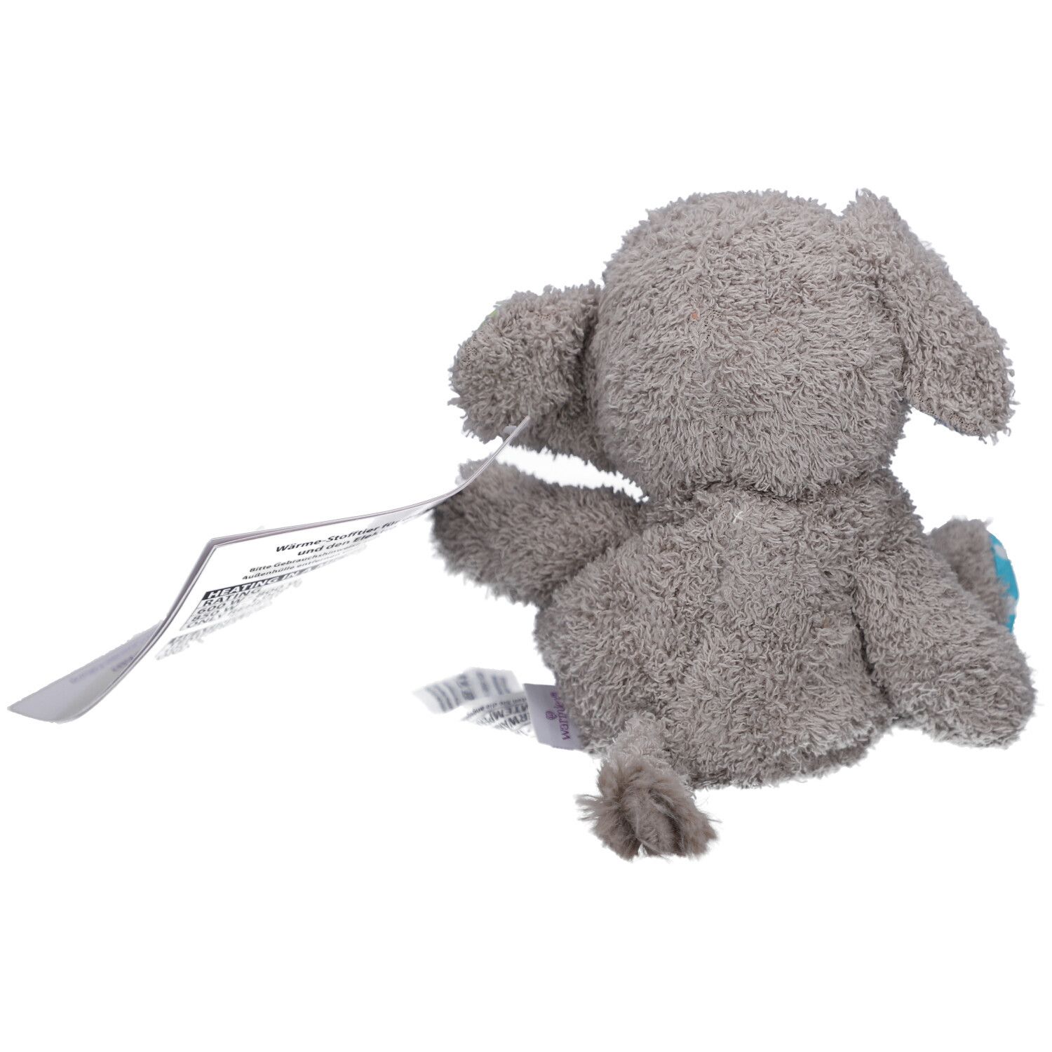 Vista posteriore di un elefante di peluche grigio con etichetta. Piccola punta della coda visibile.