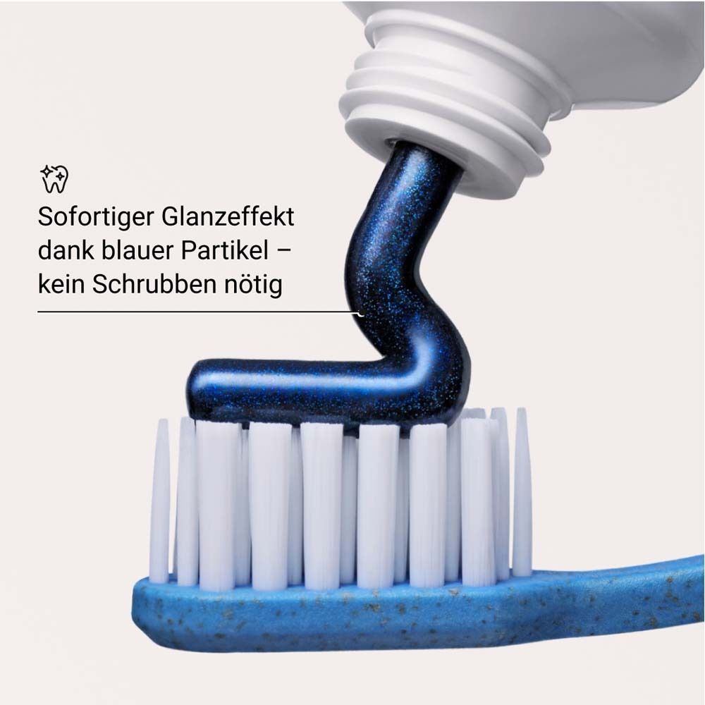Dentifricio blu su uno spazzolino. Testo: Effetto lucido immediato grazie alle particelle blu.
