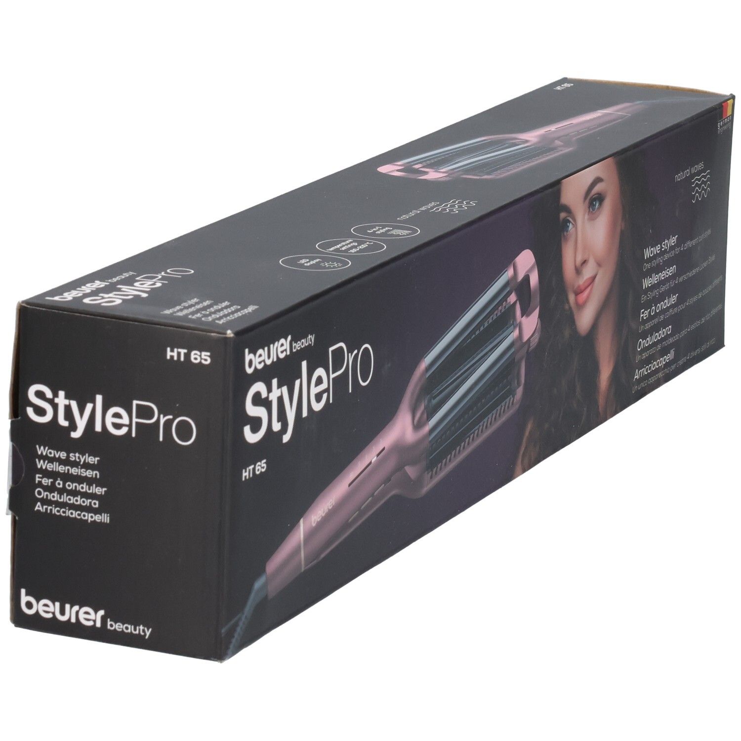 Arricciacapelli Beurer StylePro HT 65 nella confezione. Dispositivo rosa con piastre ondulate. Scritte: Wave Styler, HT 65.
