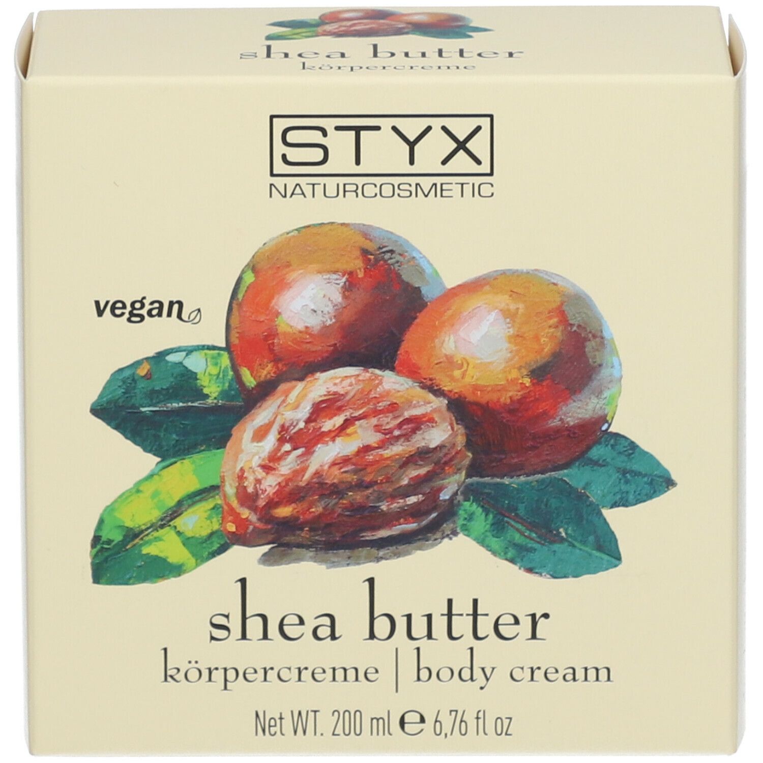 Scatola con illustrazione di noci di karité e foglie. Testo: STYX, crema corpo al burro di karité, vegan.