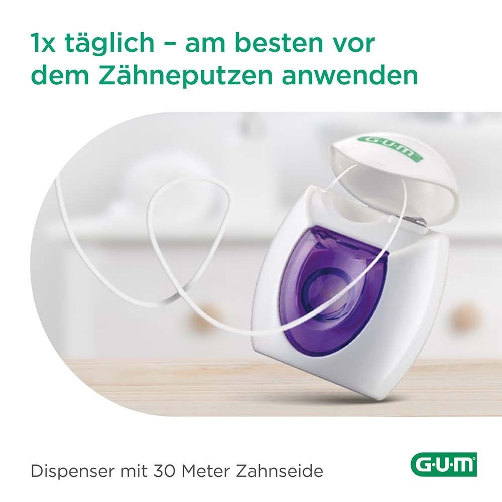 Erogatore filo interdentale aperto. Filo interdentale bianco estratto. Logo GUM. Testo: 30 metri di filo interdentale.