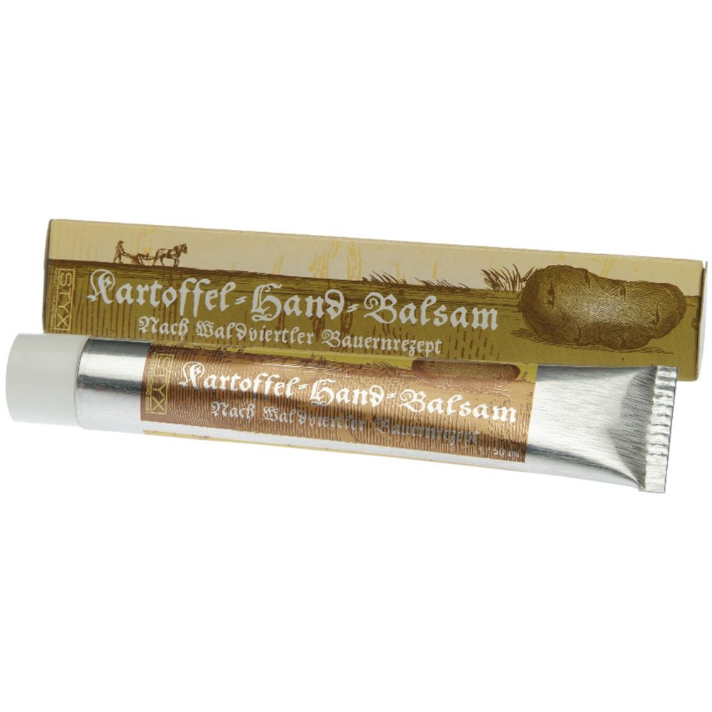 Tubo e scatola di balsamo per le mani. Tubo metallico, scatola con nome del prodotto e illustrazione di patata. Testo: Kartoffel-Hand-Balsam.