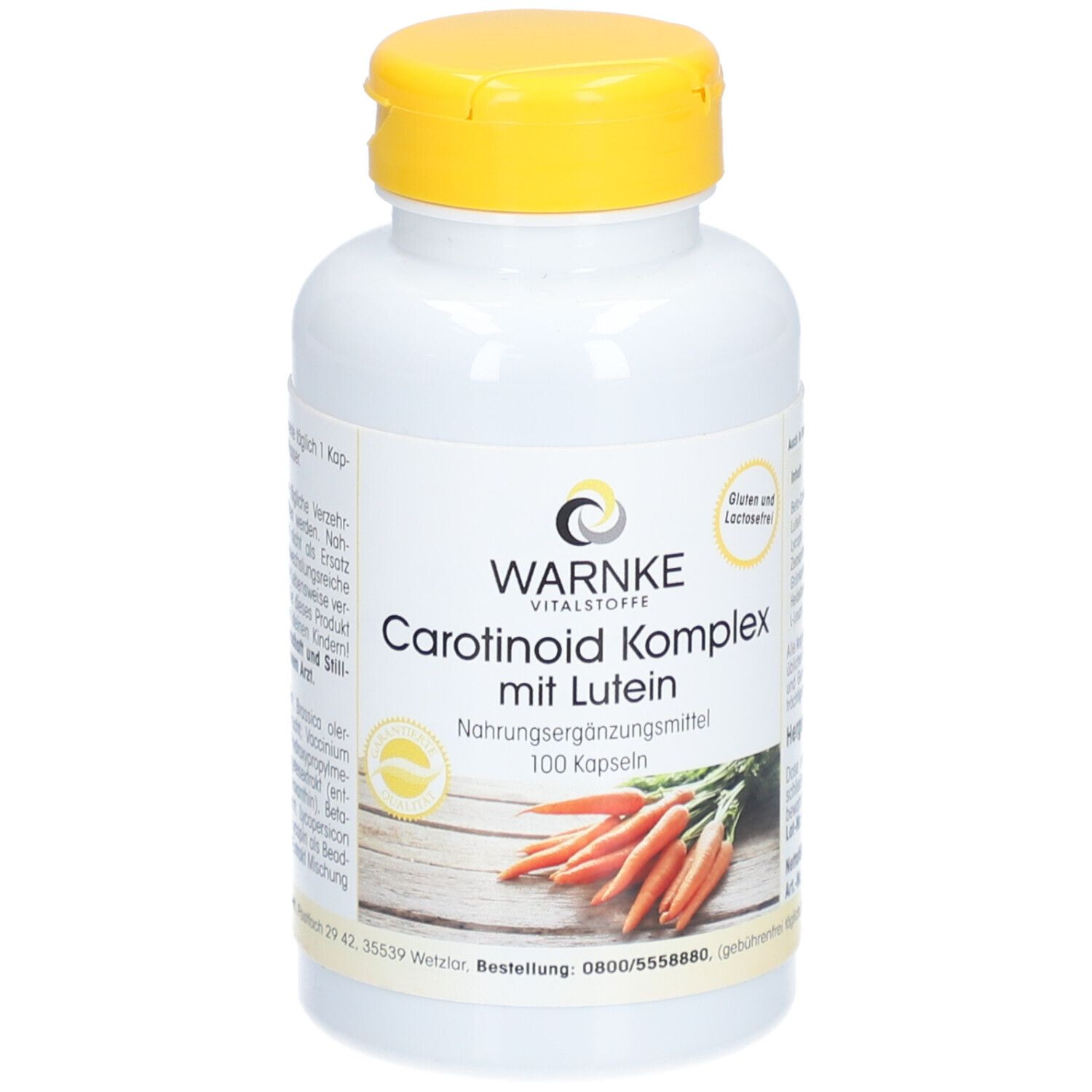 Flacone bianco con tappo giallo. Scritta: WARNKE Vitalstoffe, Carotinoid Komplex mit Lutein, 100 capsule. Immagine di carote.