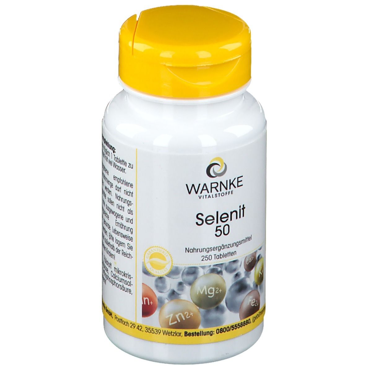 Flacone bianco con tappo giallo. Scritta: WARNKE Selenit 50. 250 compresse. Integratore alimentare. Illustrazione di minerali.