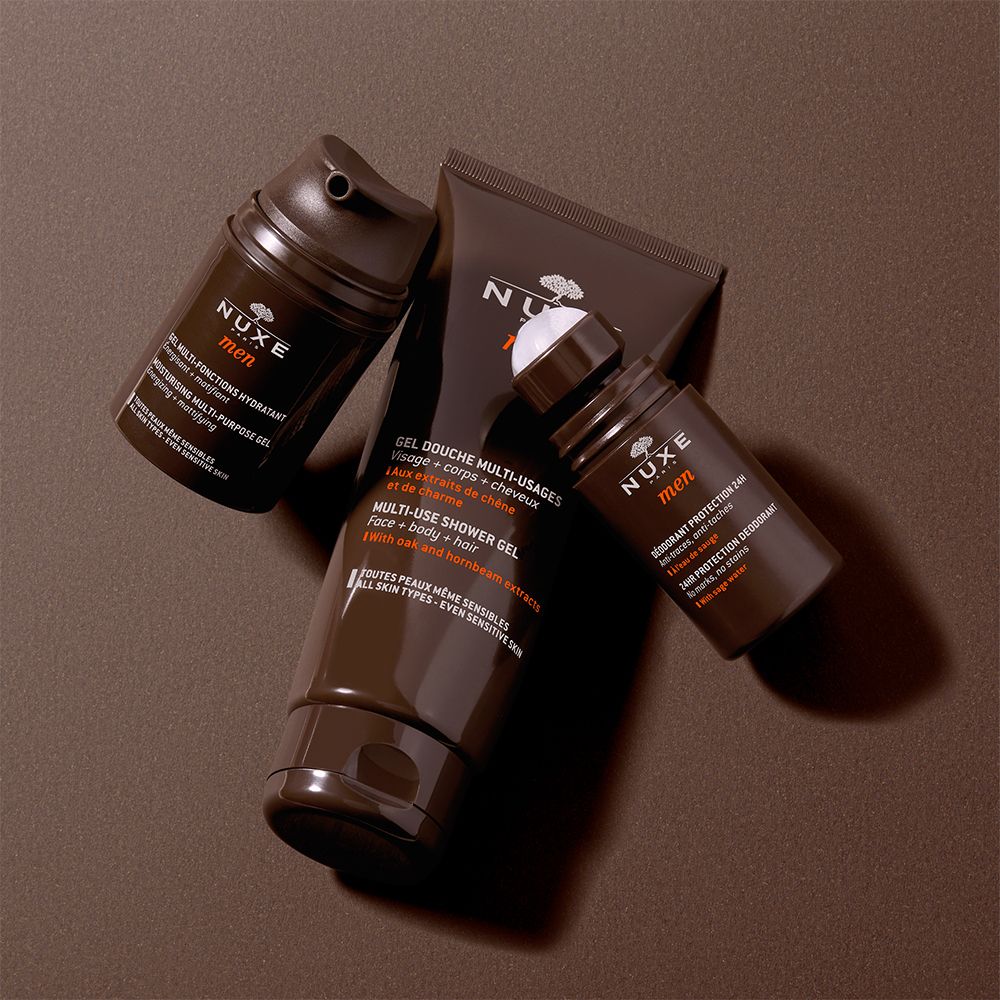 Tre prodotti NUXE Men: roll-on, gel doccia e idratante. Confezione marrone. Logo NUXE Men. Protezione 24H.