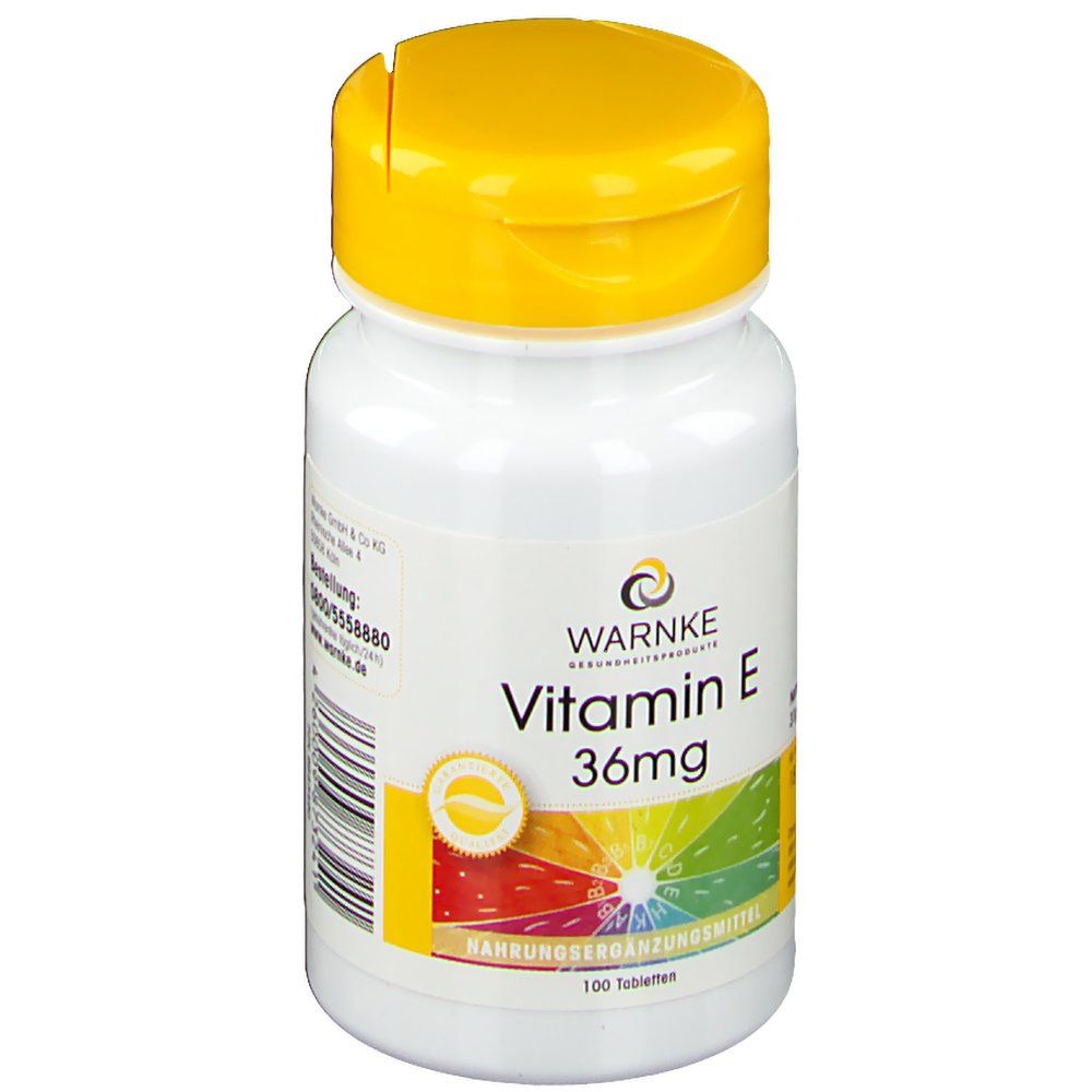 Flacone bianco con tappo giallo. Scritta: WARNKE Vitamina E 36mg. 100 compresse. Integratore alimentare. Logo.