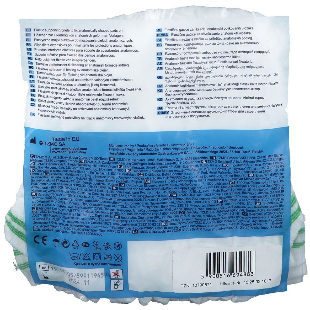 Retro della confezione con testo multilingue. Mutanda di fissaggio bianca con bordo verde. Codice a barre e informazioni di produzione.