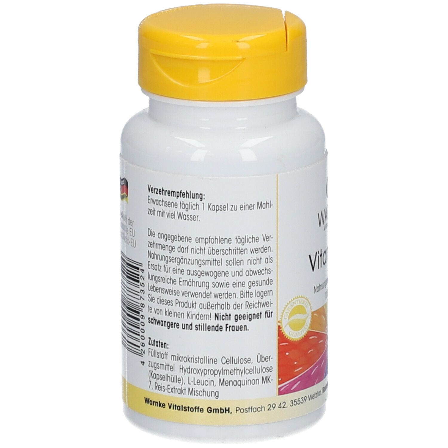 Retro del flacone bianco con tappo giallo. Testo: Raccomandazioni, ingredienti, avvertenze. Stampa bandiera tedesca.