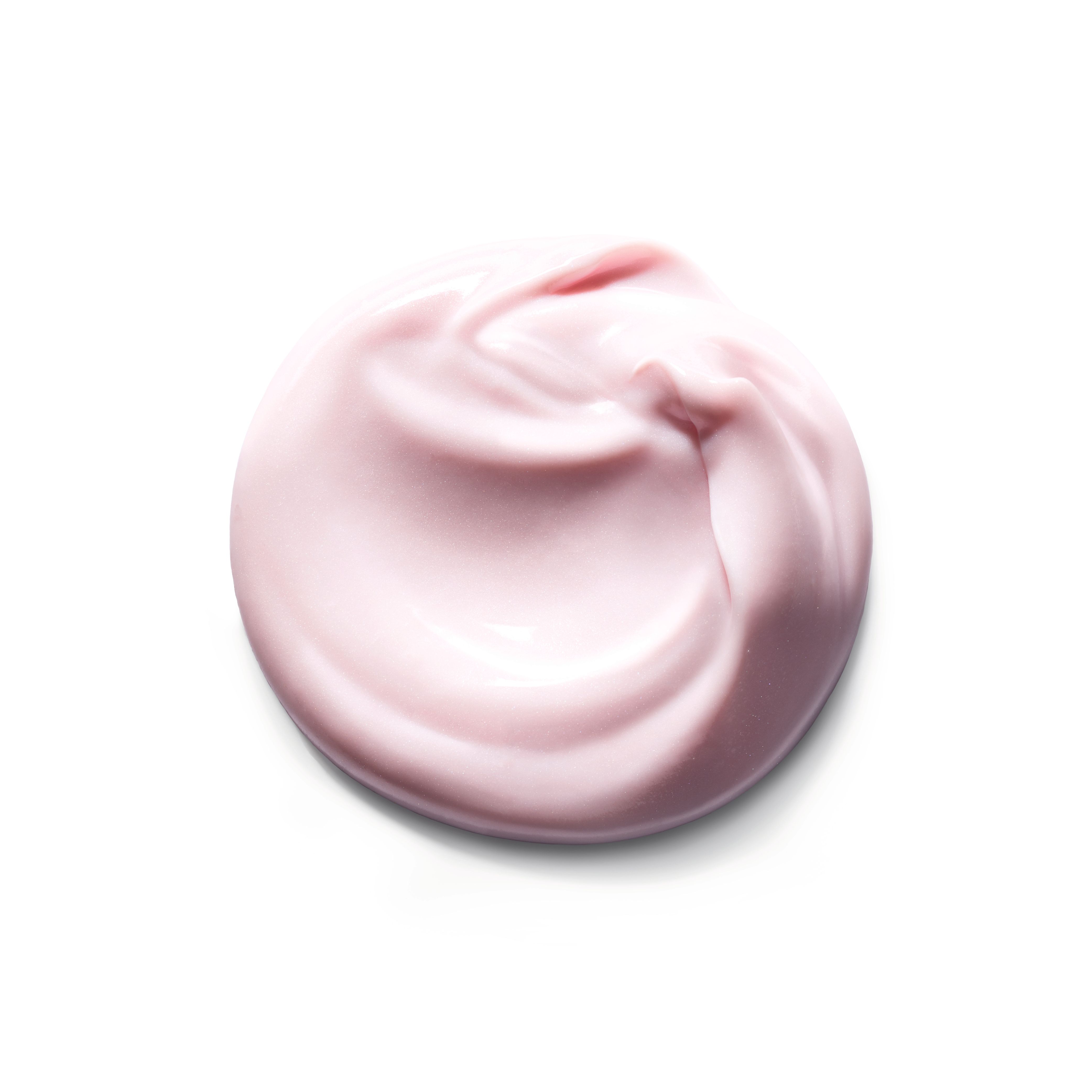 Macchia di crema rosa su sfondo bianco. Forma rotonda, superficie ondulata.