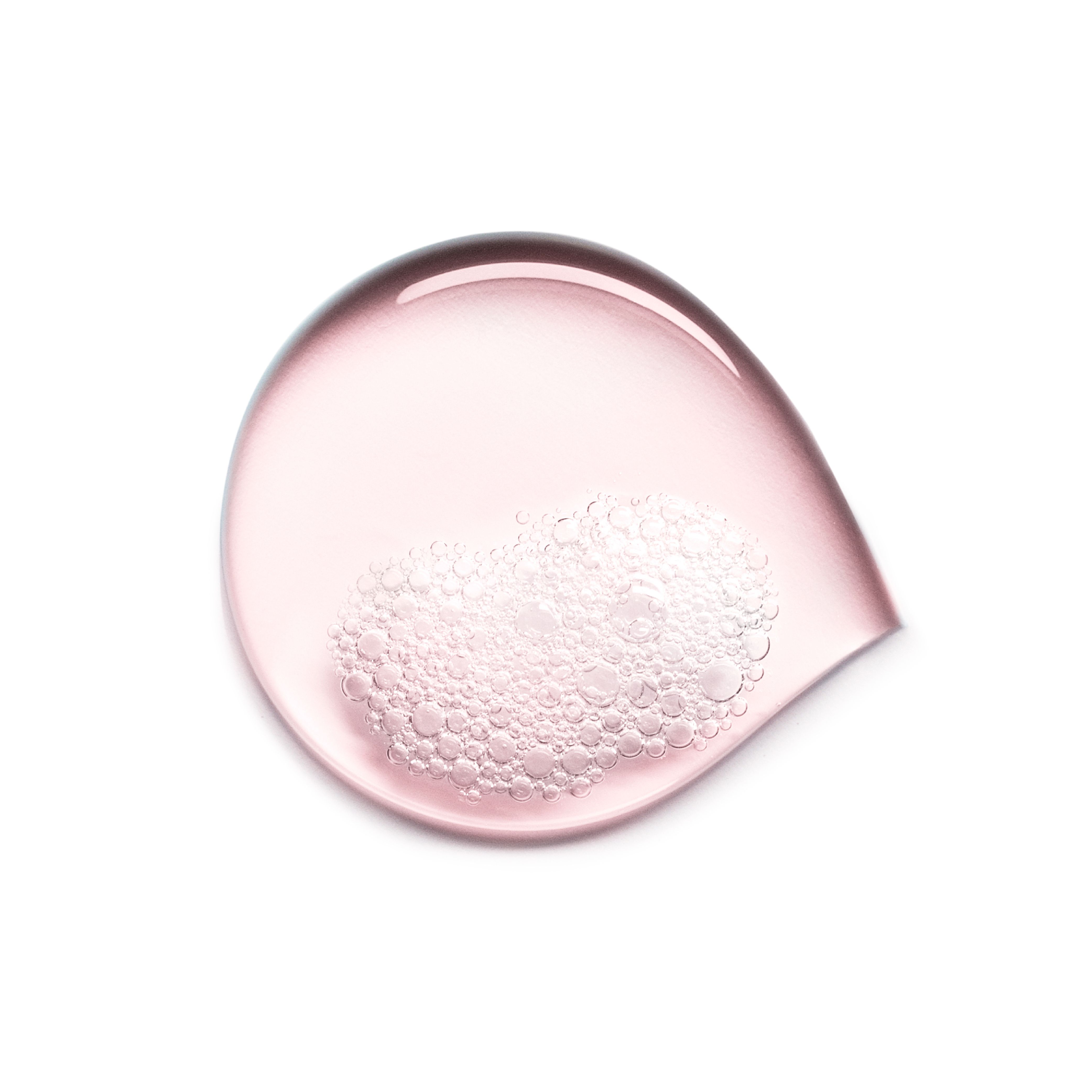Test di gel rosa traslucido a forma di goccia con bolle d'aria.