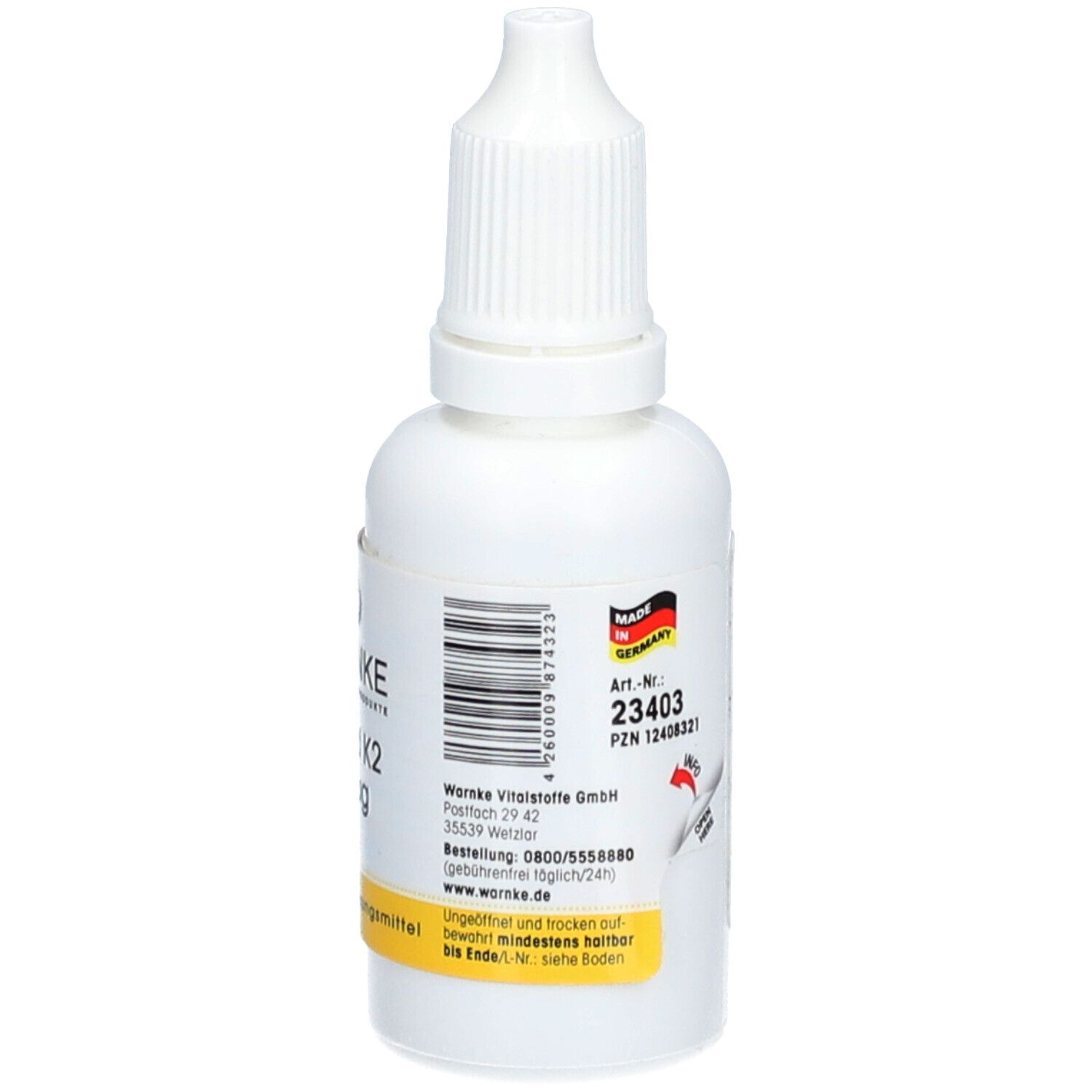 Flacone bianco con contagocce. Adesivo con testo e codice a barre. Prodotto in Germania. Etichetta gialla: Integratore alimentare.