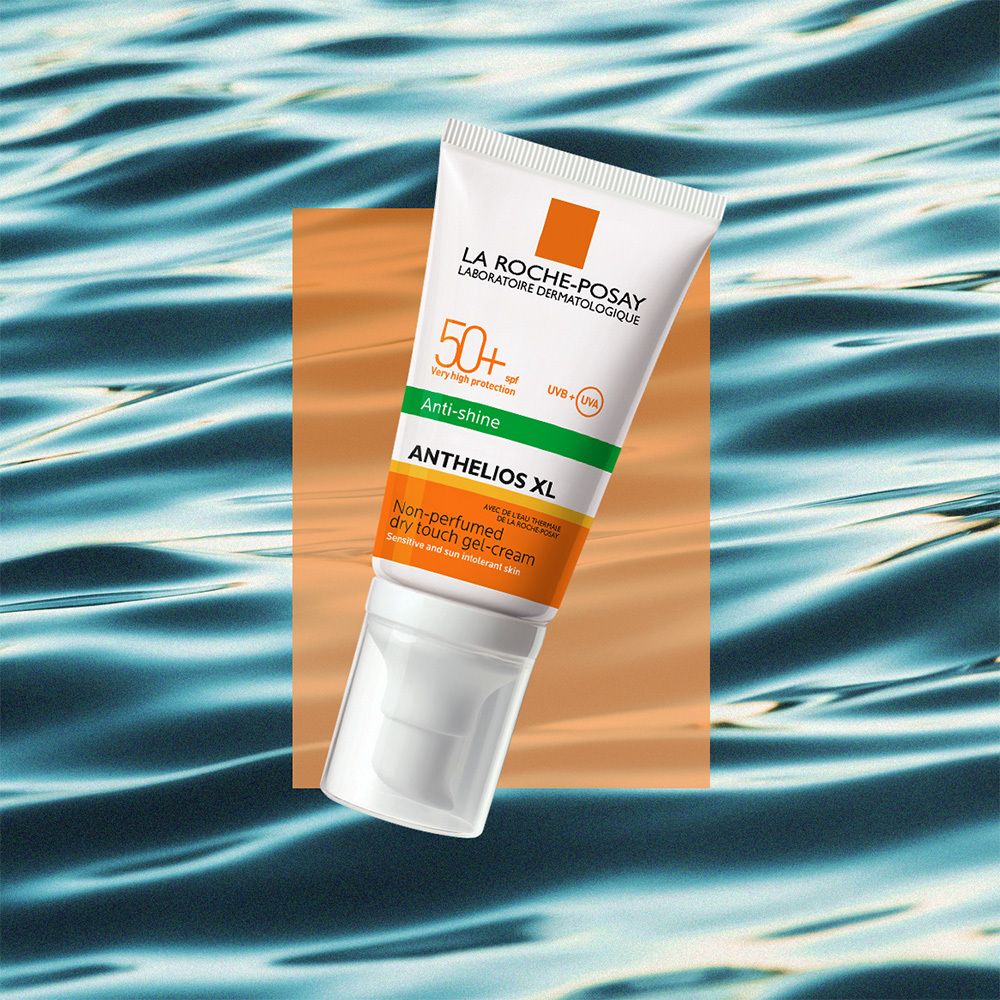 Tubo di crema solare, bianco, accenti arancioni e verdi. Testo: Anthelios XL 50+.
