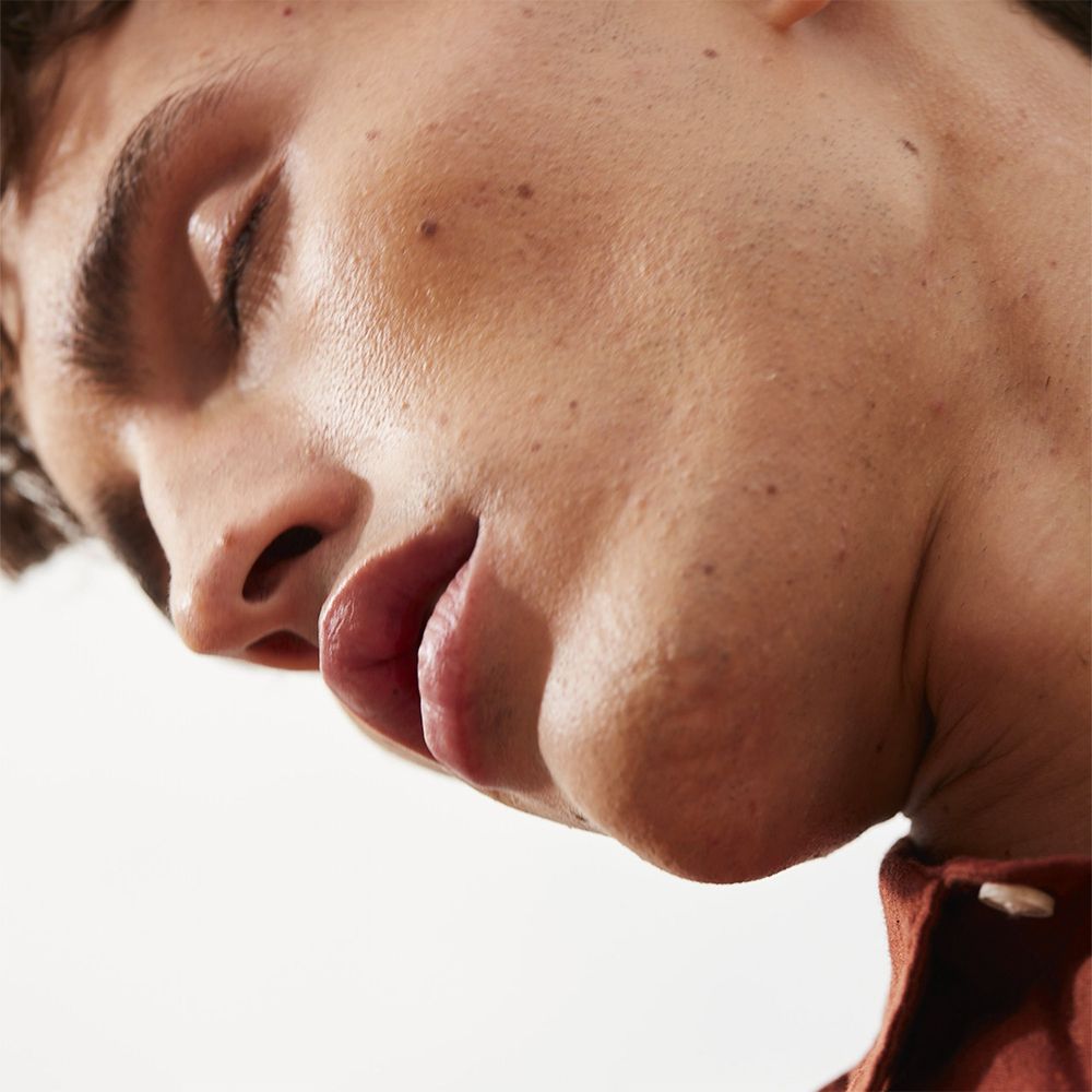Primo piano di un uomo. Occhi chiusi, pelle chiara.