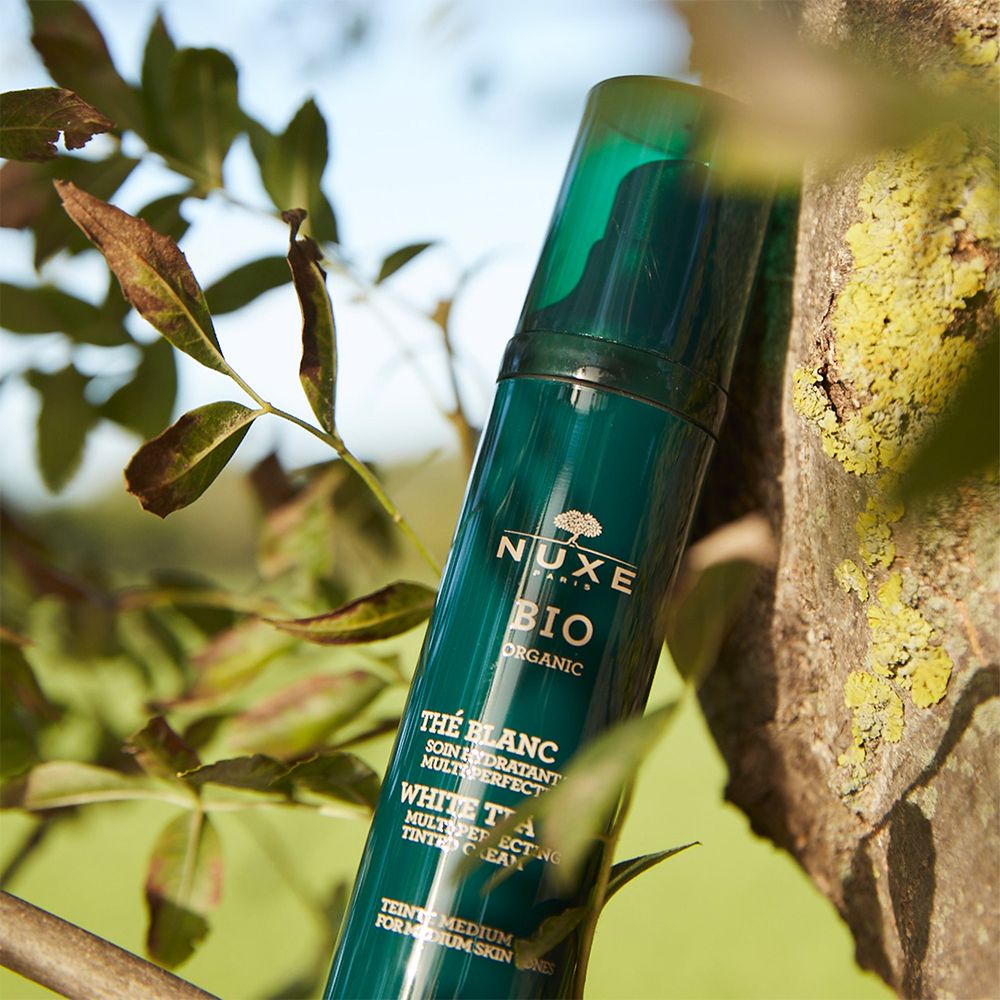 Flacone verde con dosatore tra i rami. Scritta: NUXE BIO, Thé Blanc. Per pelli medie.