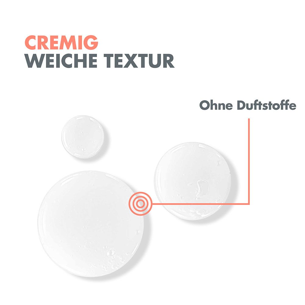 Tre gocce di un liquido chiaro e cremoso su sfondo bianco. Una mostra un bersaglio. Etichettato "Texture cremosa e morbida" e "Senza profumo".