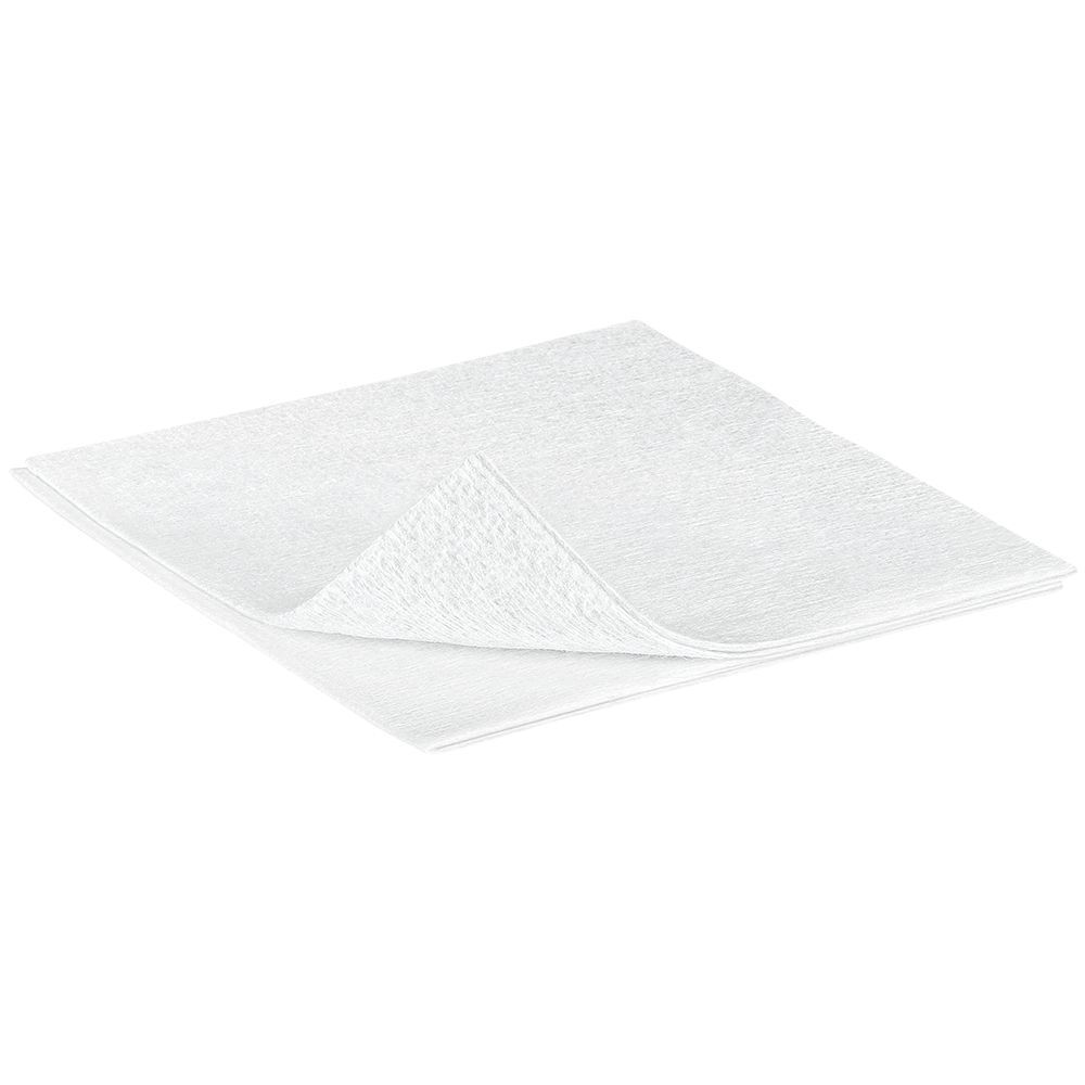 Compressa in tessuto non tessuto bianca. Quadrata, superficie leggermente rigata. Singola, leggermente sovrapposta.