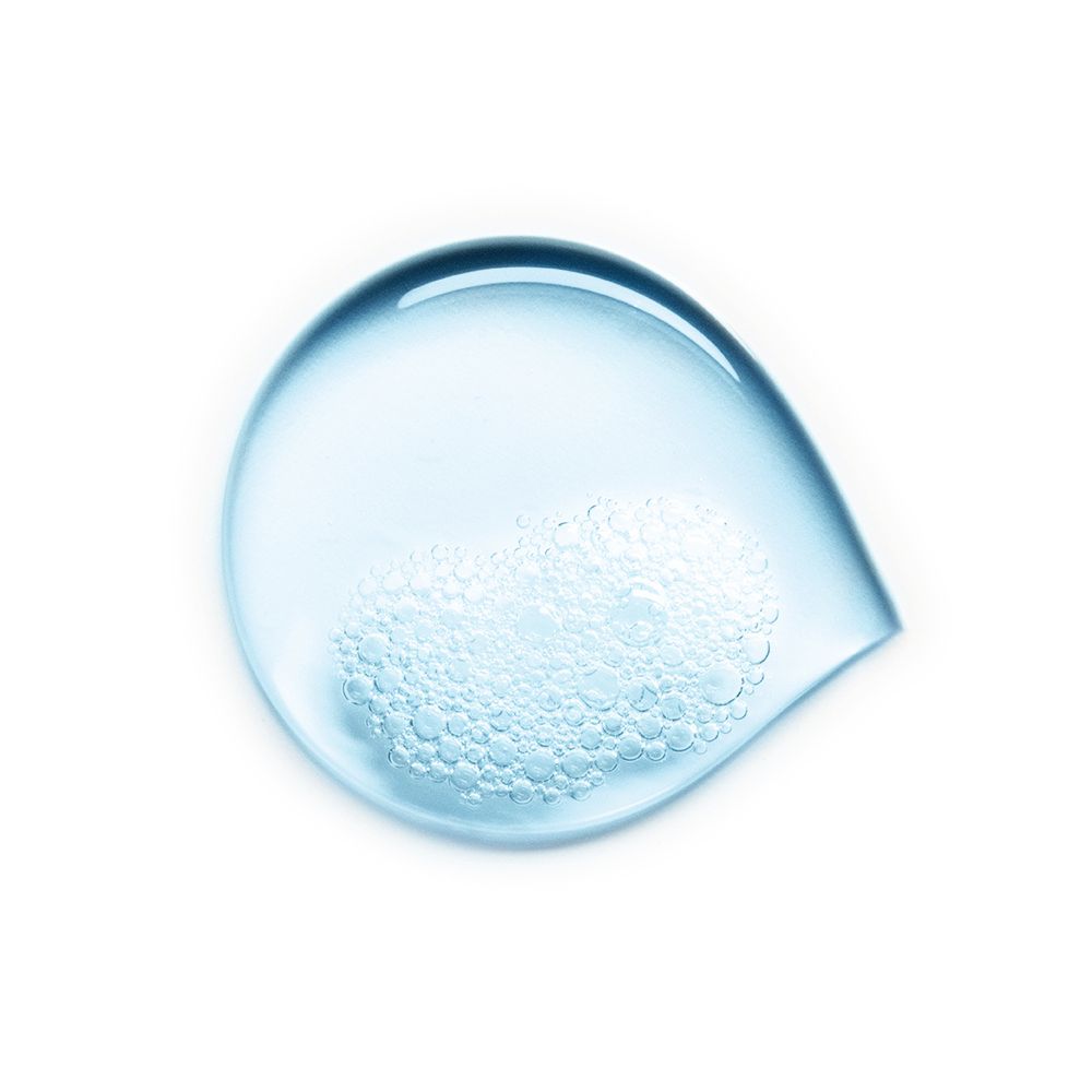 Un campione di liquido blu a forma di goccia con piccole bolle d'aria.
