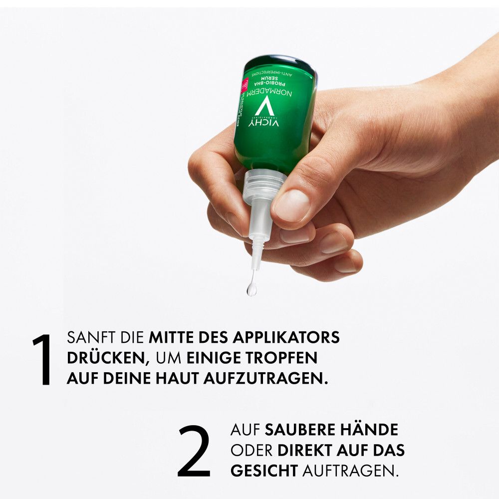 Mano che tiene il flacone del siero. Testo: 1. Premere il centro dell'applicatore. 2. Applicare sul viso.