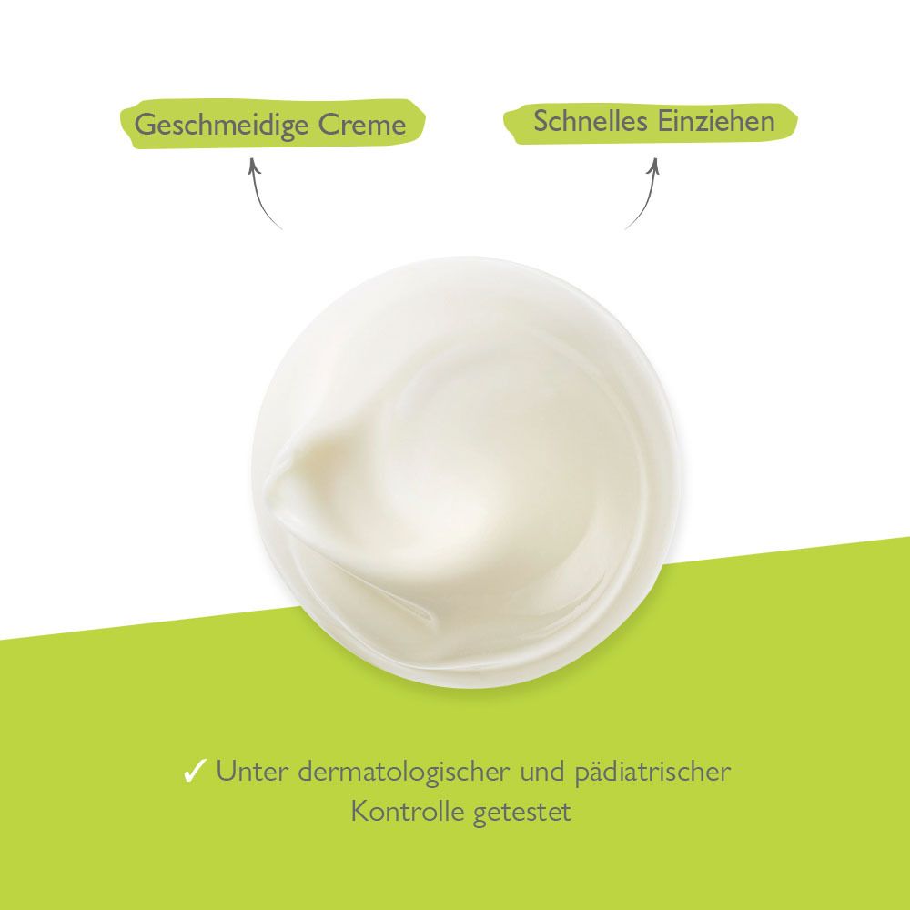 Primo piano della crema. Testo: Crema liscia, rapido assorbimento. Testato sotto controllo dermatologico e pediatrico.