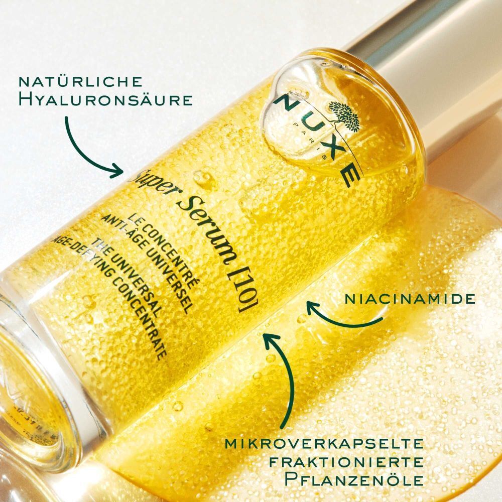 Primo piano di NUXE Super Serum [10]. Frecce indicano ingredienti: acido ialuronico, niacinamide, oli vegetali.