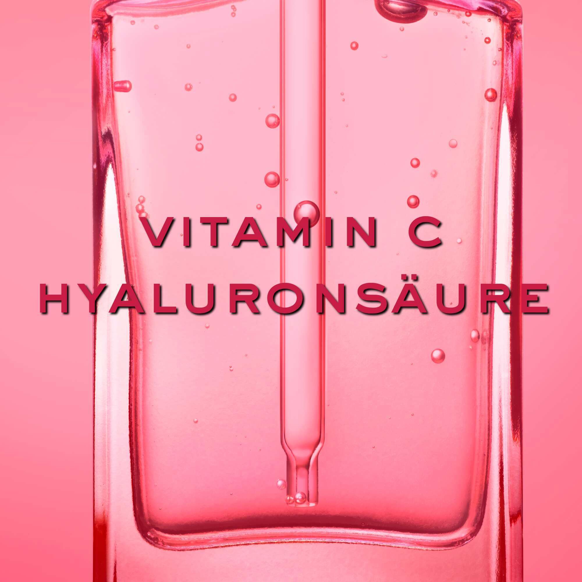 Primo piano di una pipetta in un liquido rosa. Testo: Vitamina C Acido Ialuronico.
