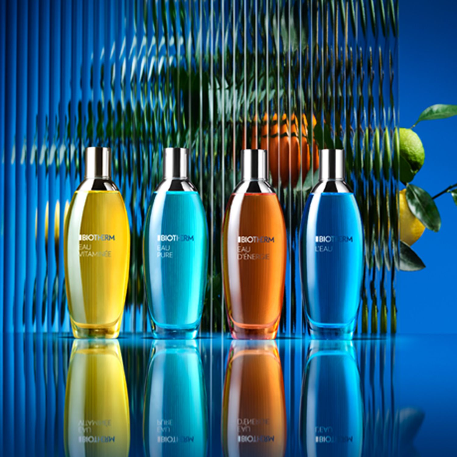 Quattro flaconi di diversi colori. Scritta: BIOTHERM. Sfondo blu.