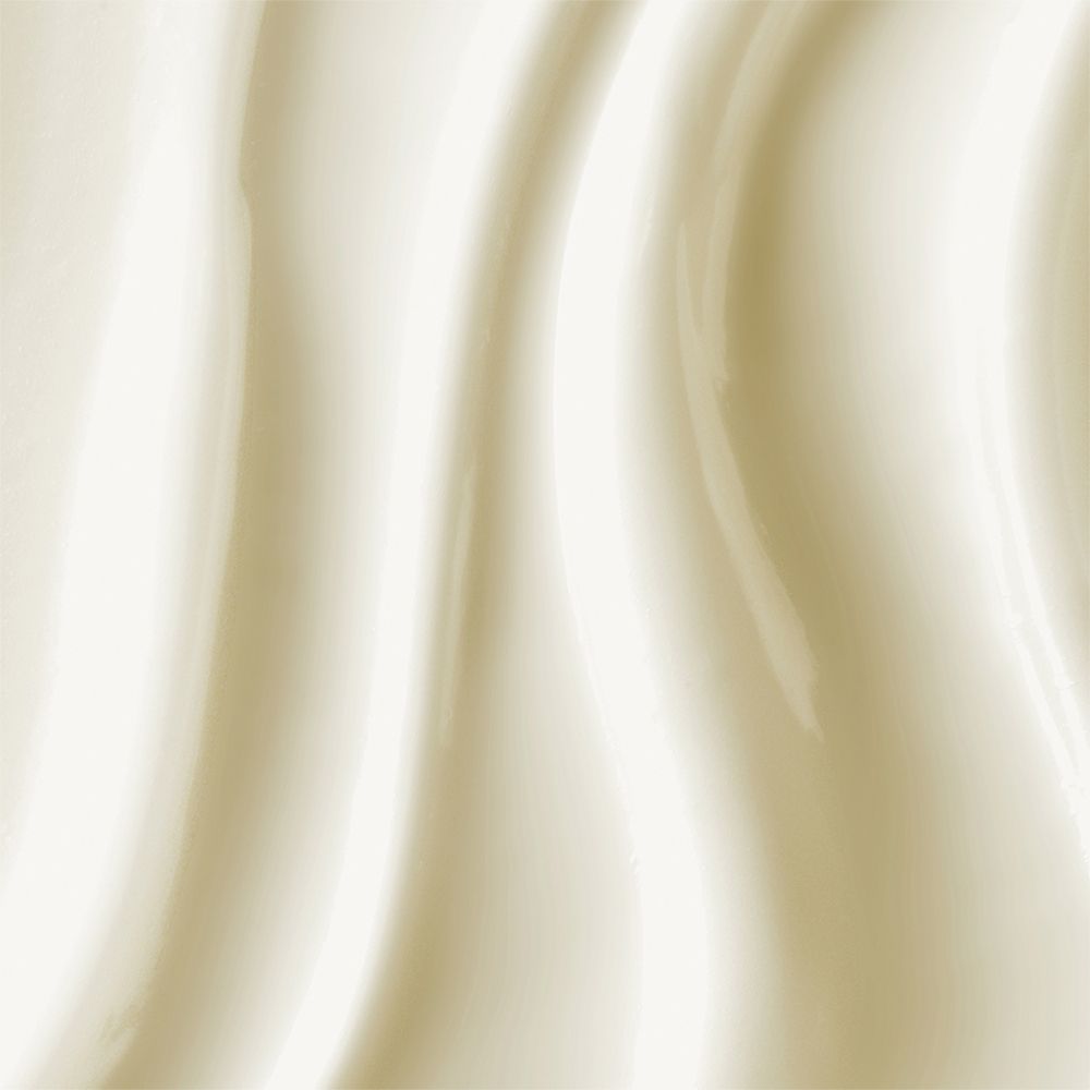 Primo piano di crema solare. Texture cremosa con linee ondulate. Tonalità chiare e crema.