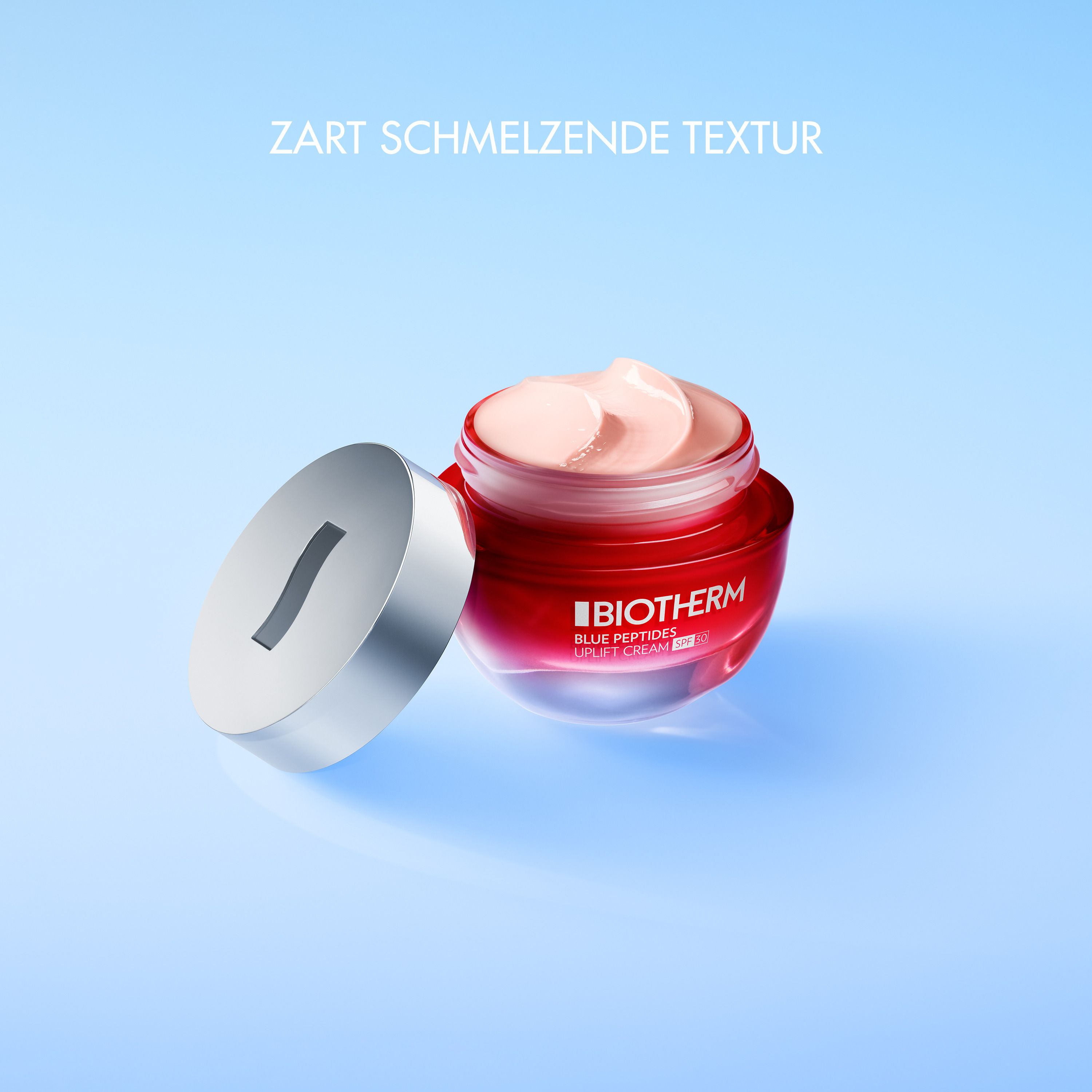 Vasetto aperto con crema. Coperchio accanto. Scritta: BIOTHERM BLUE PEPTIDES UPLIFT CREAM SPF 30.
