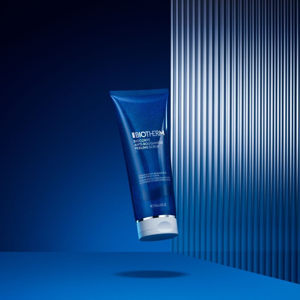 Tubo blu con tappo bianco su sfondo blu. Scritta: Biotherm, Biocorps Anti-Roughness Peeling Scrub.