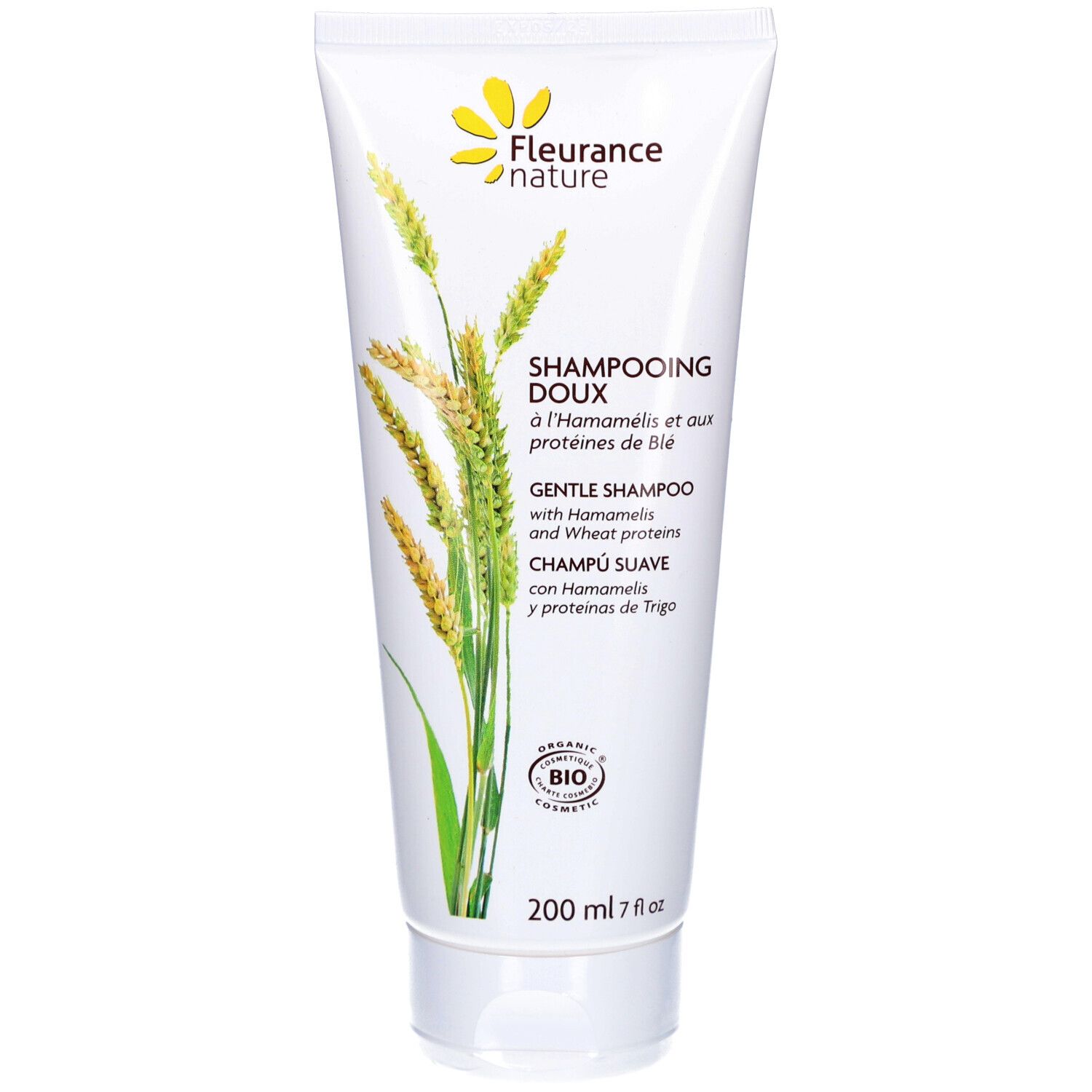 Tubo di shampoo bianco con logo floreale giallo. Testo: "Shampooing Doux" e "Gentle Shampoo". Certificazione bio.