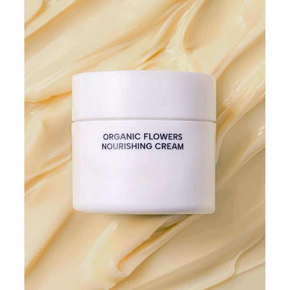 Vasetto bianco su sfondo color crema. Scritta: ORGANIC FLOWERS NOURISHING CREAM.