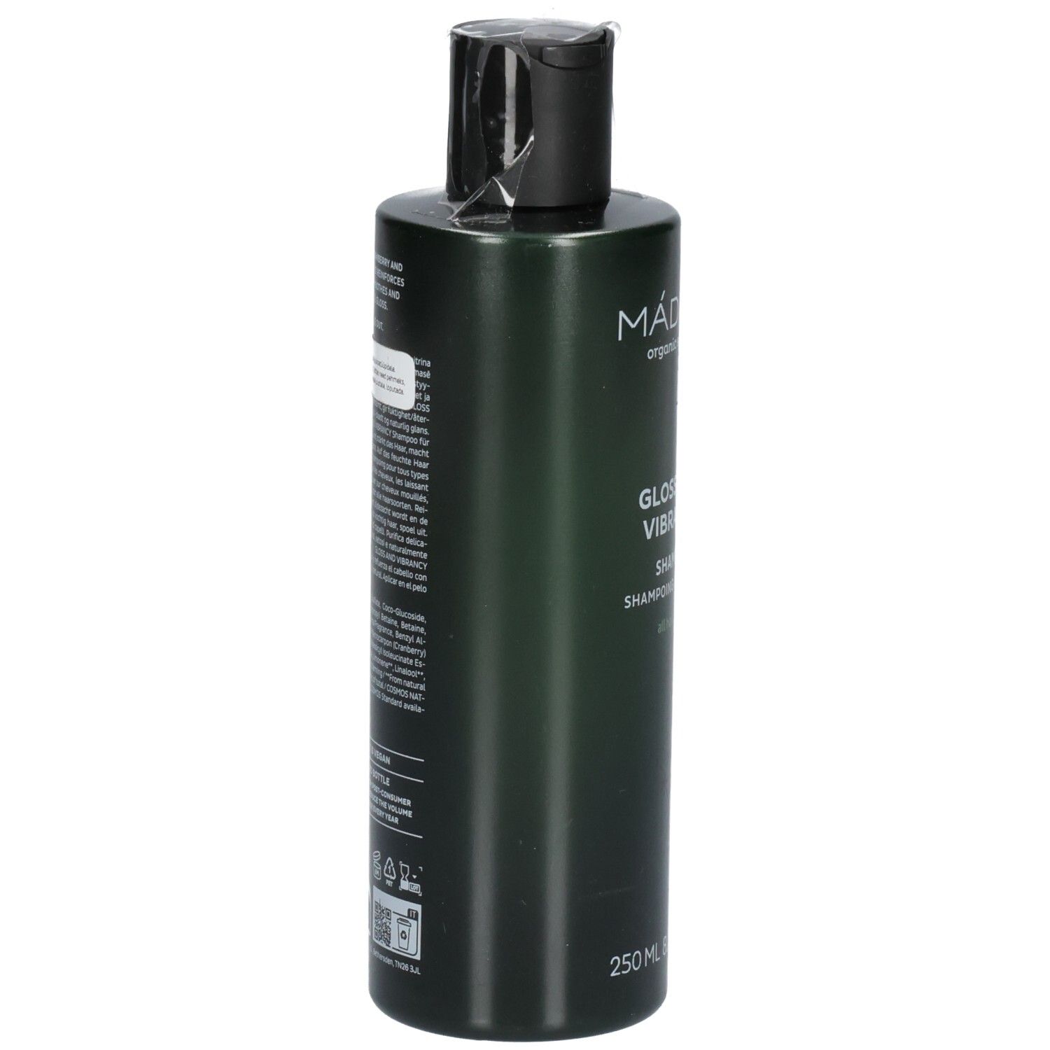 Retro di un flacone di shampoo verde. L'etichetta contiene ingredienti e istruzioni per l'uso.