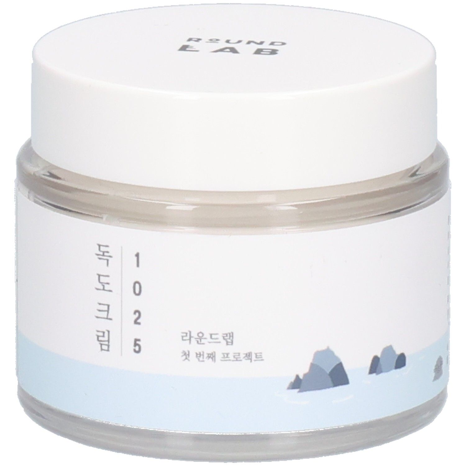 Vaso rotondo trasparente con coperchio bianco. Etichetta con testo coreano e logo. "ROUND LAB" in alto.