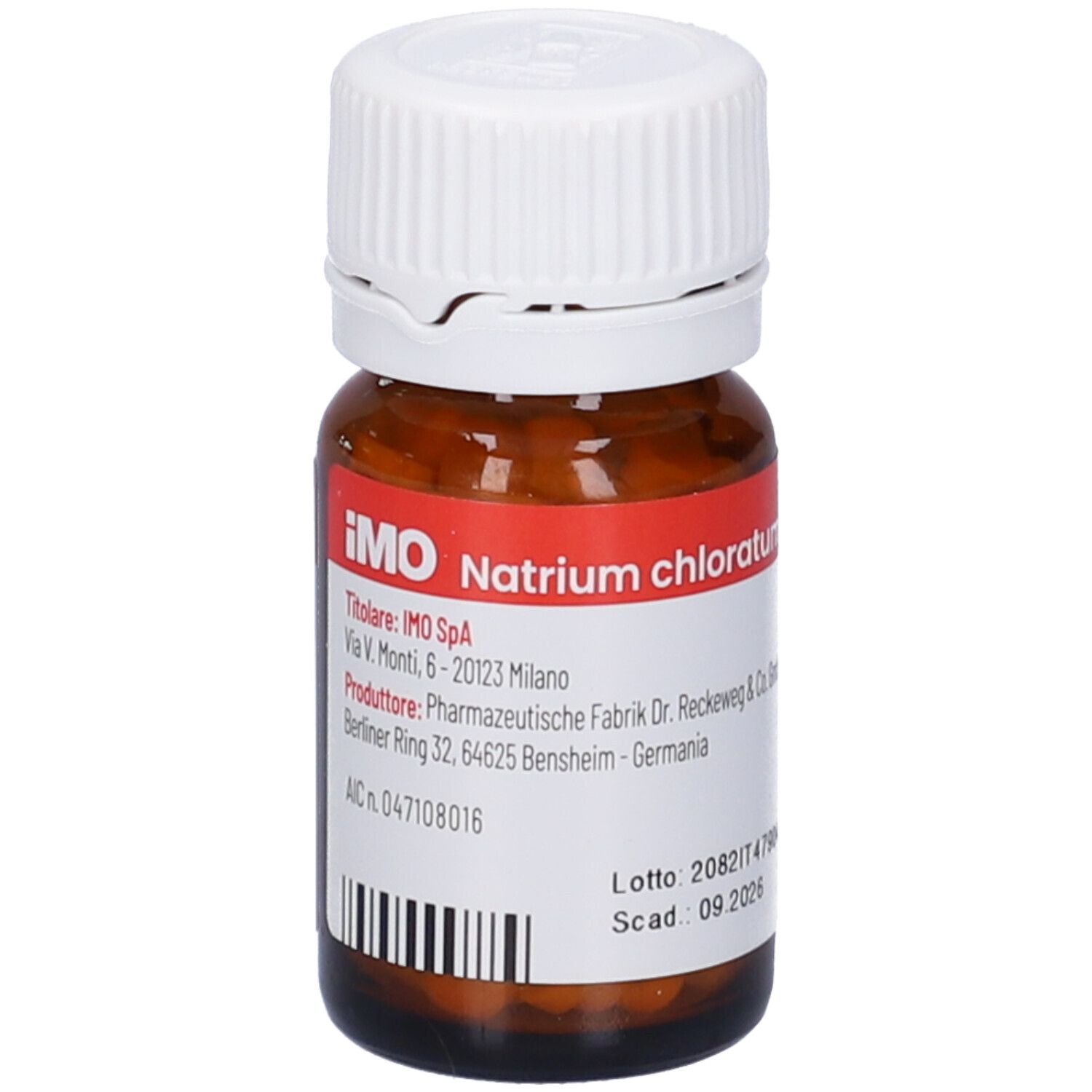 Flacone di vetro marrone con tappo bianco. Etichetta con informazioni sul prodotto. Compresse all'interno visibili. Codice a barre.