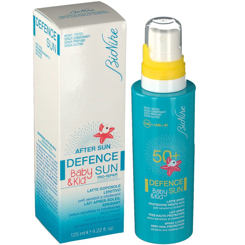 Flacone e scatola di crema solare turchese. Scritta: Defence Baby Sun & Kid, 50+. Contiene After Sun.