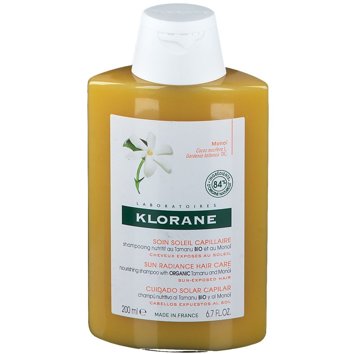 Flacone di shampoo giallo con tappo bianco. Scritta: Klorane, Soin Soleil Capillaire. 84% ingredienti naturali.