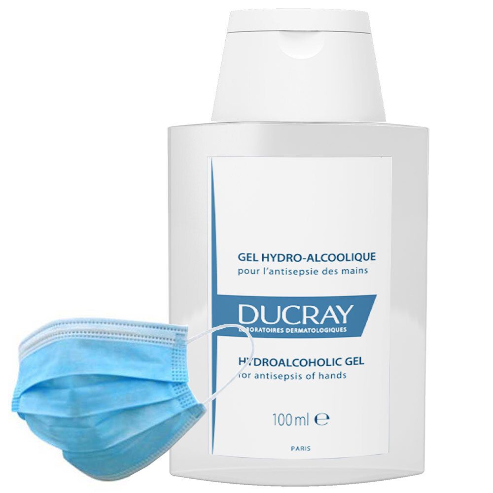 Mascherina blu e flacone bianco di gel idroalcolico DUCRAY. Scritta: GEL HYDRO-ALCOOLIQUE pour l'antisepsie des mains.