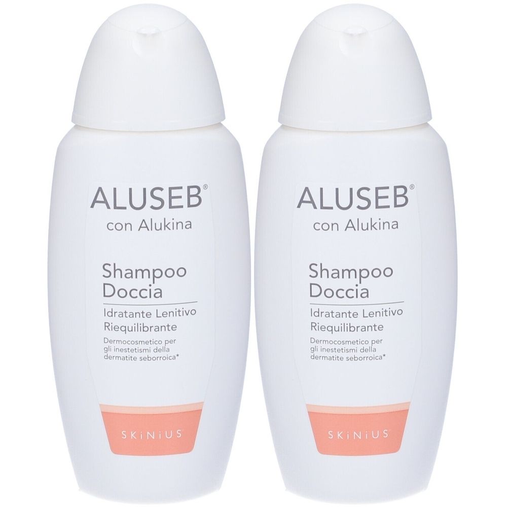 Due flaconi bianchi di shampoo con la scritta ALUSEB con Alukina. Scritta: Shampoo Doccia, Idratante Lenitivo Riequilibrante. Marchio SKINIUS.