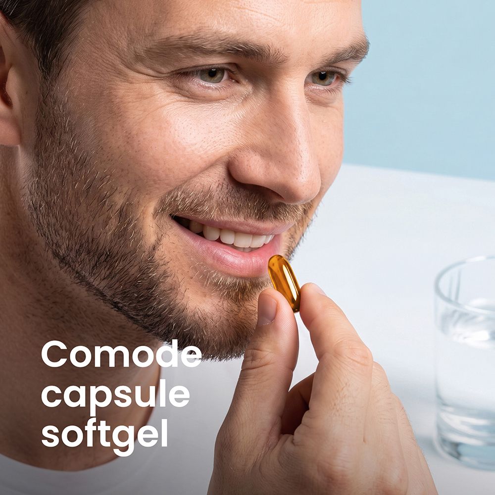 Un uomo prende una capsula molle dorata.