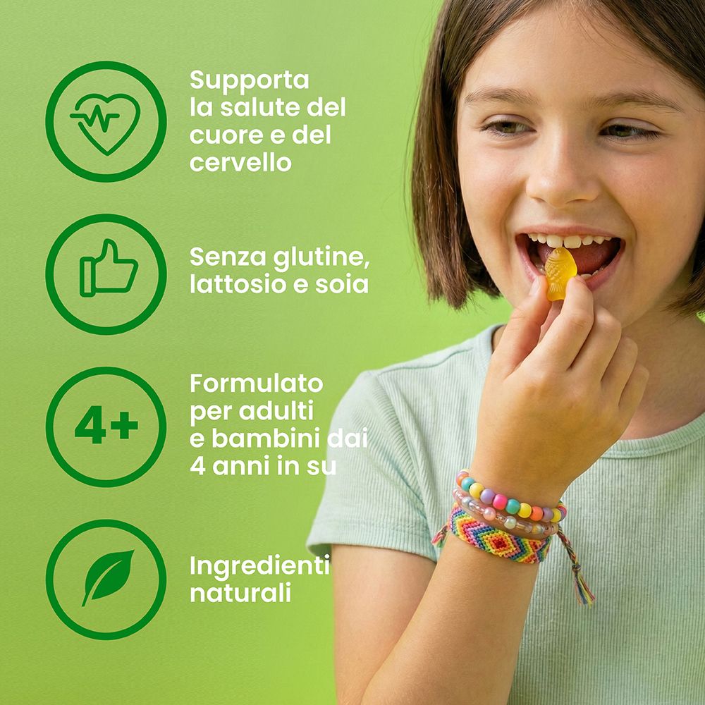 Bambina mangia una gommosa Omega+DHA. Note: salute cuore, senza glutine, da 4 anni.