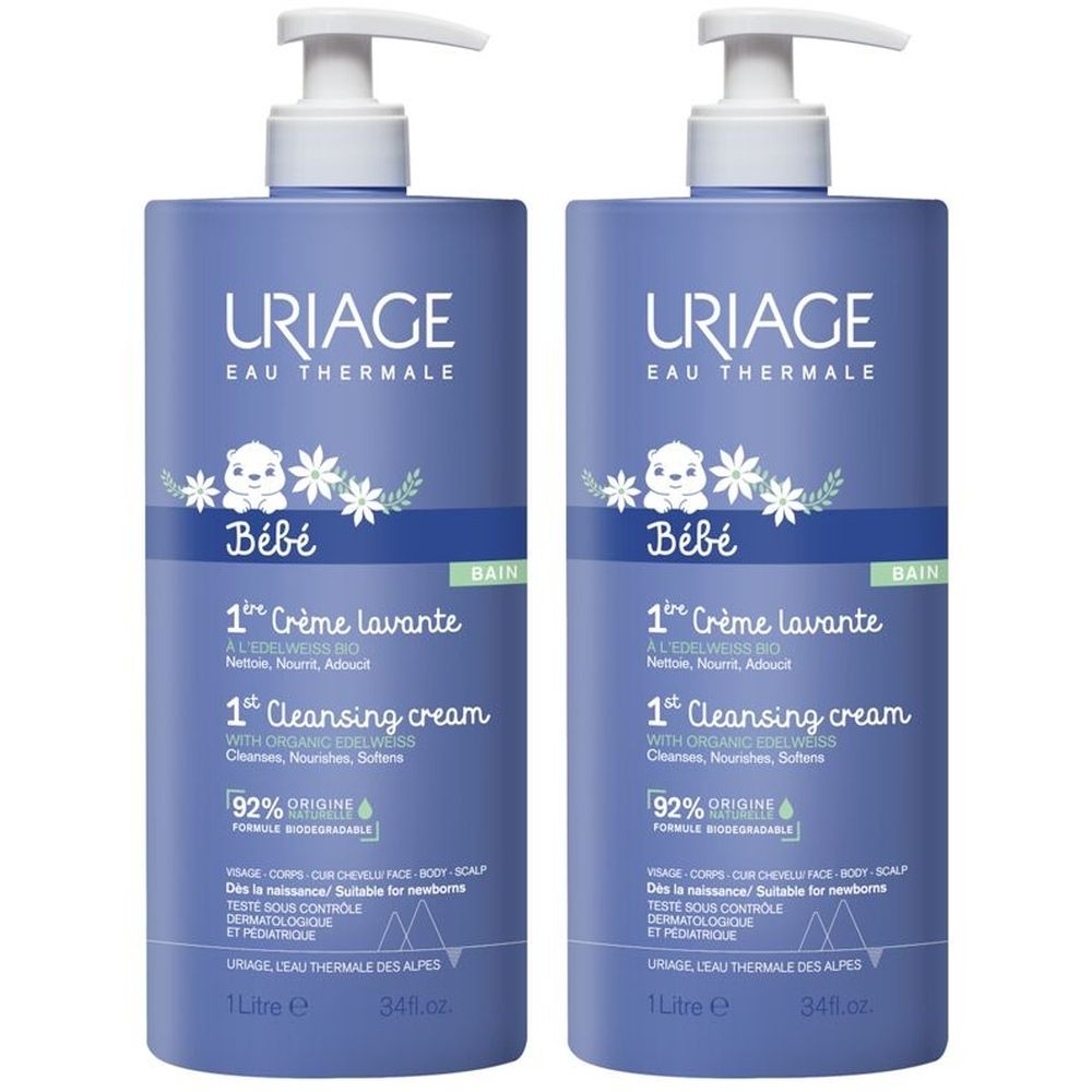Due flaconi blu con dosatore bianco. Scritta: URIAGE Bébé 1ère Crème lavante. 92% ingredienti naturali.