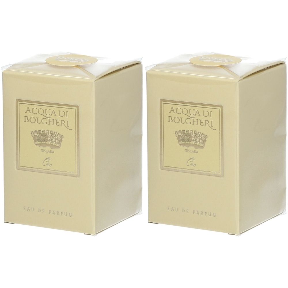 Due confezioni di profumo beige con etichetta dorata. Scritta: ACQUA DI BOLGHERI. Sigillate con adesivo rotondo.