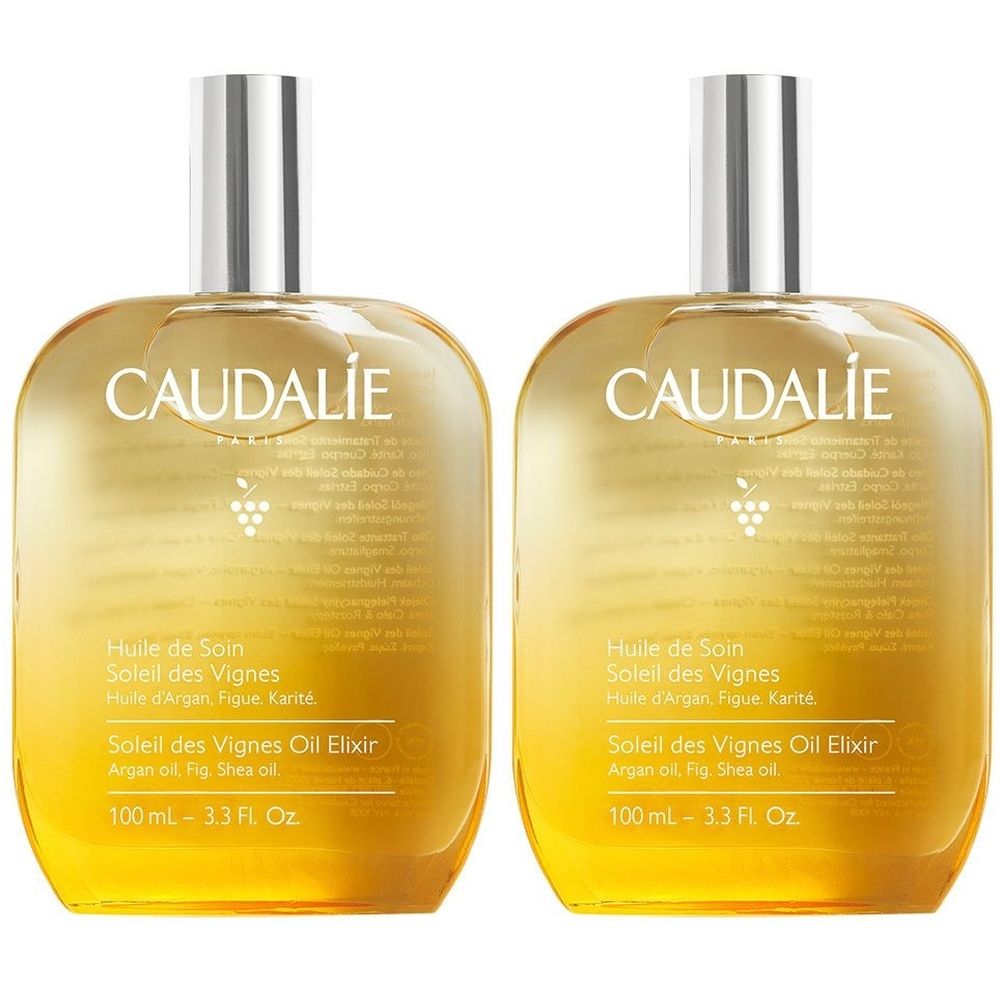 Due flaconi di olio Caudalie Soleil des Vignes. Liquido dorato in bottiglie di vetro con tappi argentati. Testo sull'etichetta.