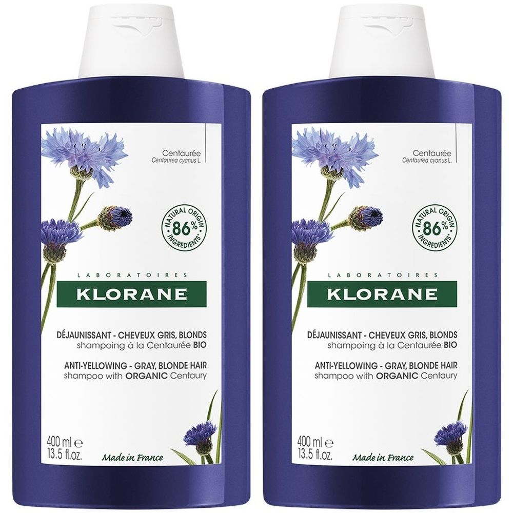 Due flaconi di shampoo blu. Scritte: KLORANE, anti-giallo, fiordaliso bio. 400 ml. Fatto in Francia. 86% ingredienti naturali.