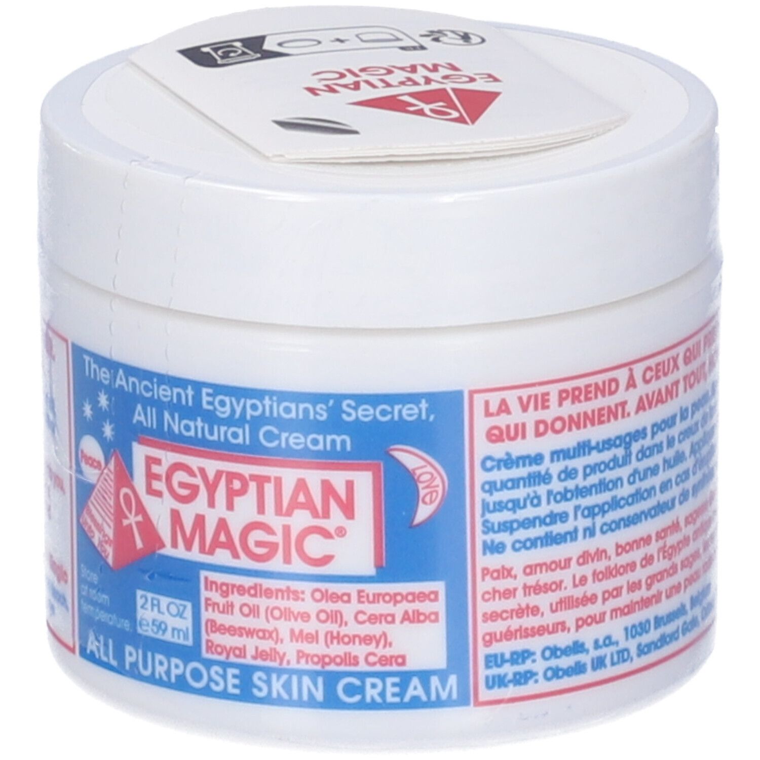 Vasetto bianco con etichetta blu. Testo: Egyptian Magic, All Purpose Skin Cream. Elenco ingredienti. Coperchio con logo.