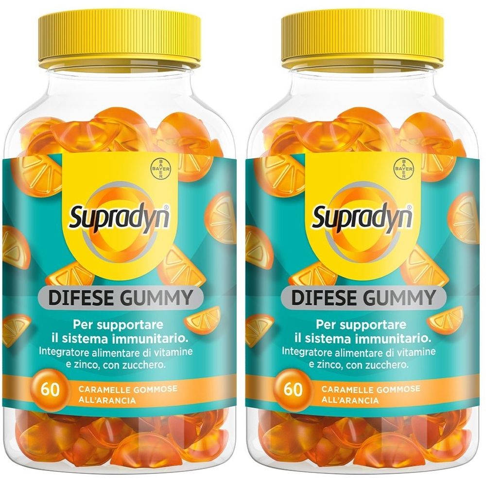 Due flaconi con tappo giallo. Scritta: Supradyn Difese Gummy. 60 caramelle gommose. Caramelle gommose arancioni in un flacone trasparente.